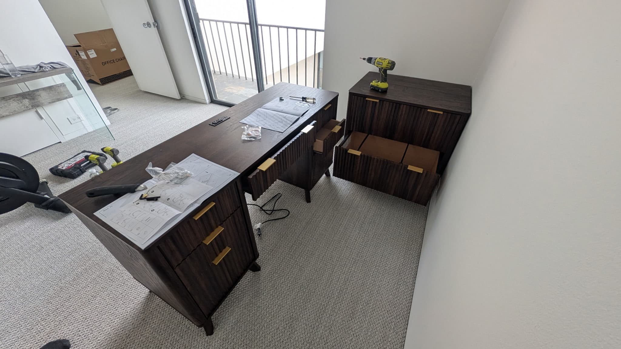 Black office desk setup with glass tops