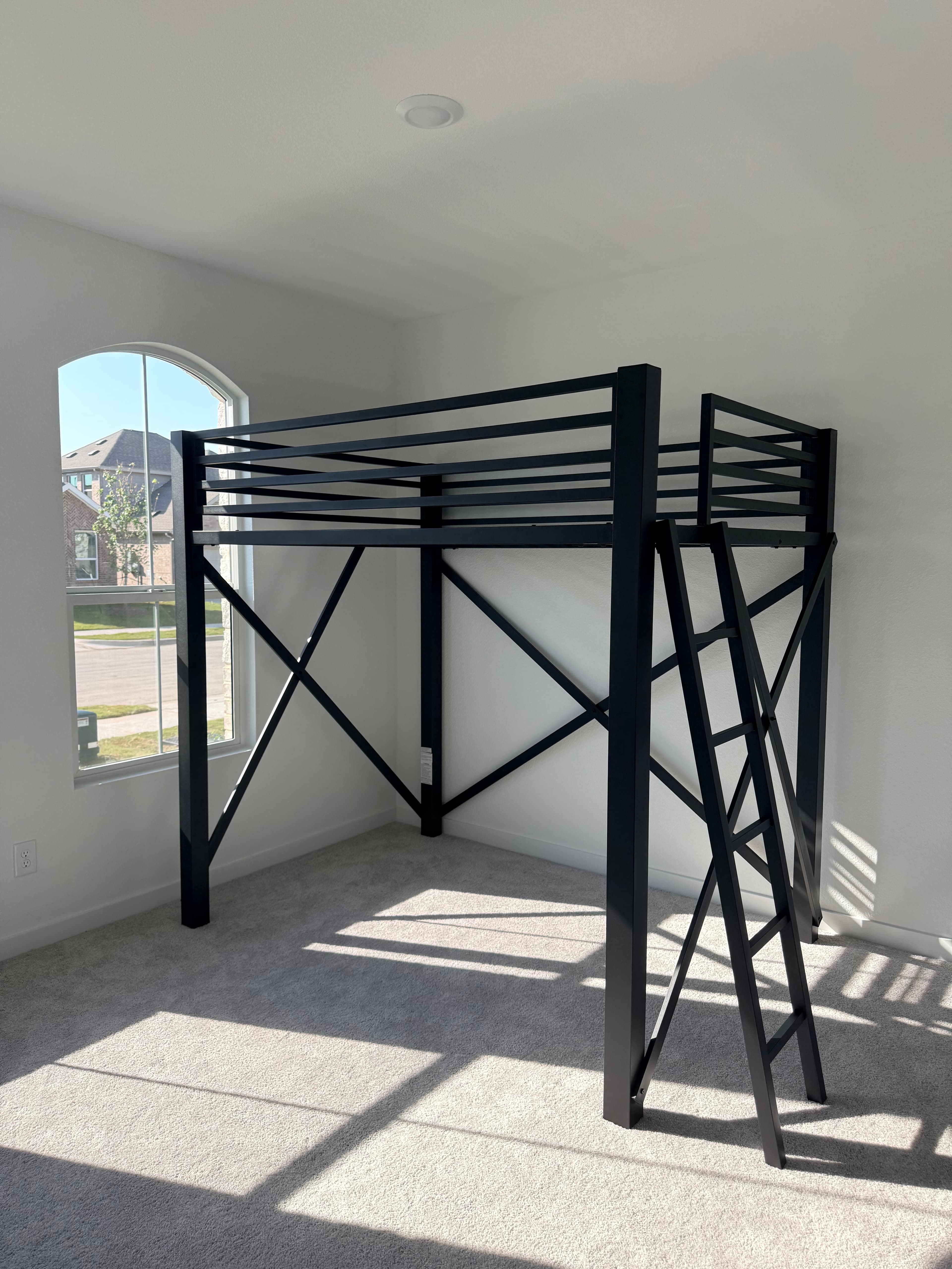 Black metal bed frame with X-pattern design