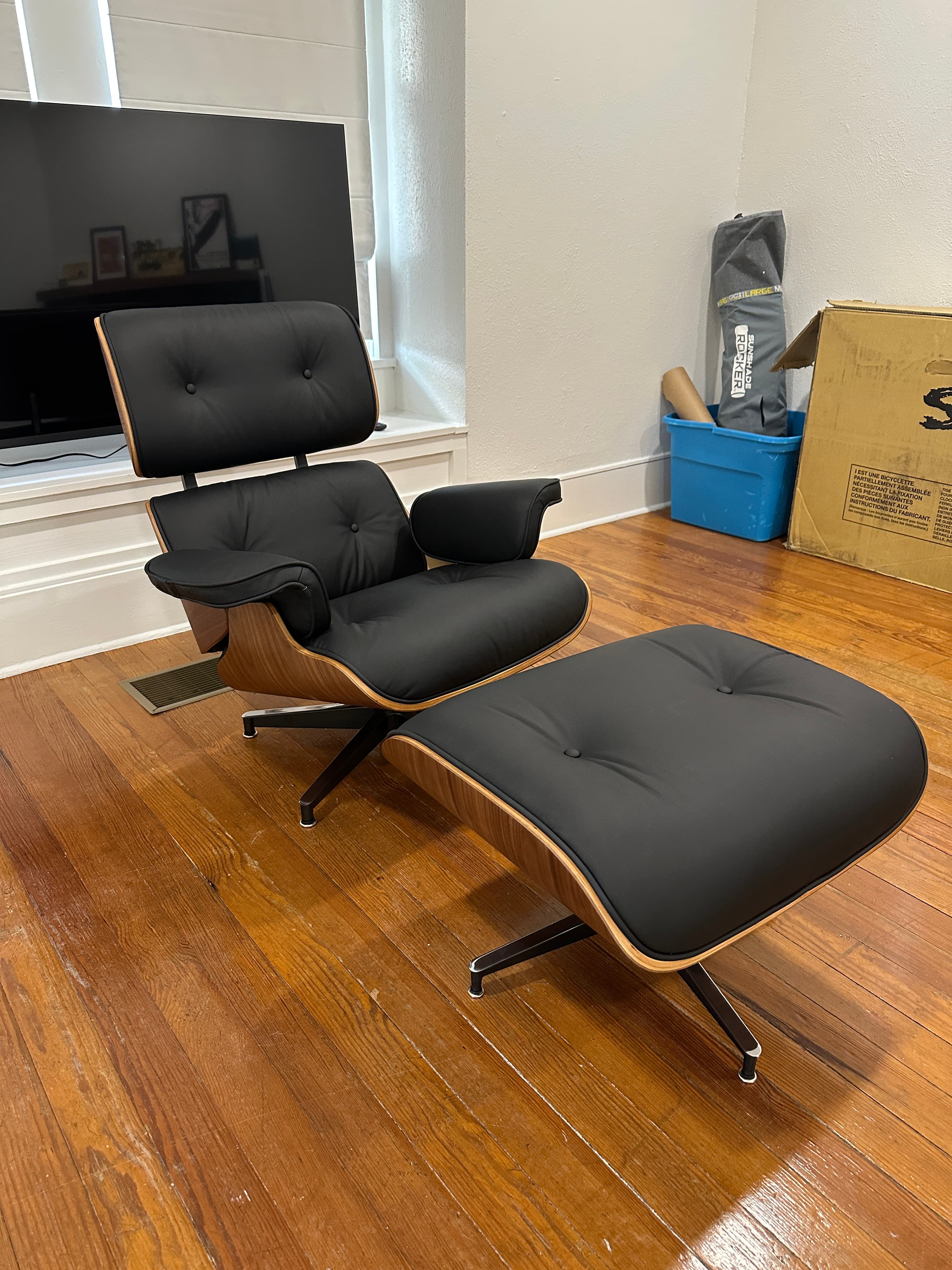 Black leather Eames-style lounge chair with ottoman