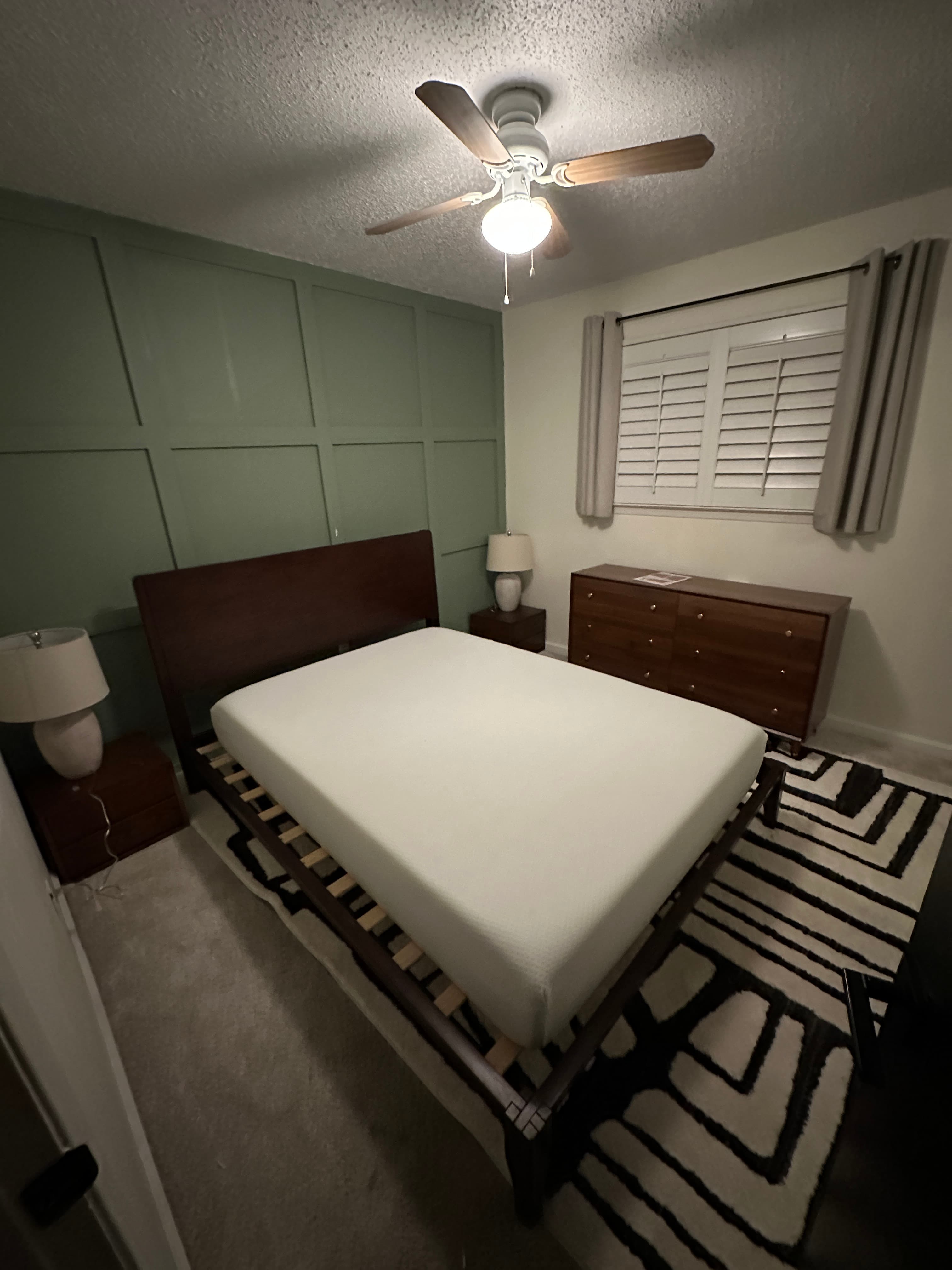 Dark wood bed with white bedding