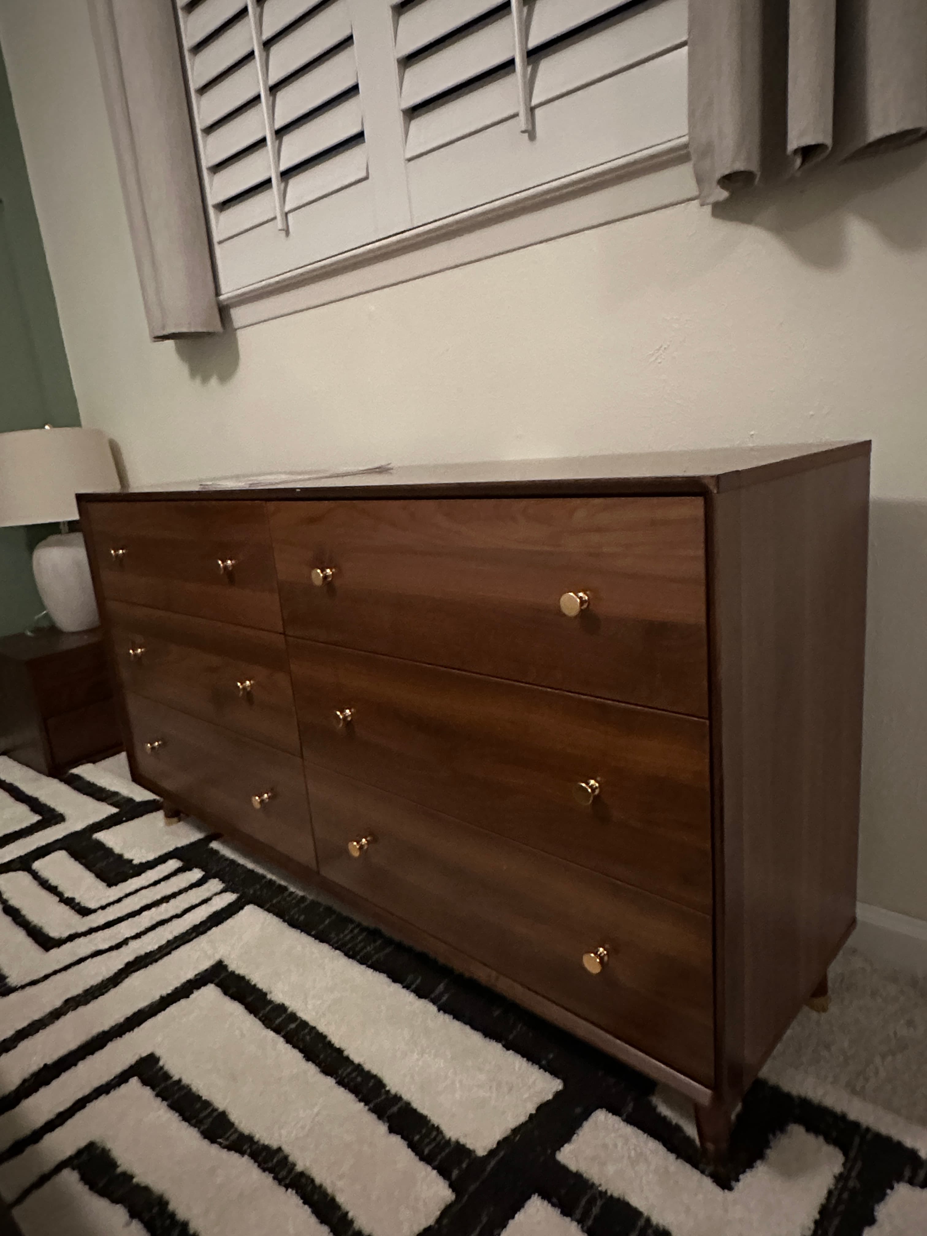 Dark brown wooden dresser with gold handles