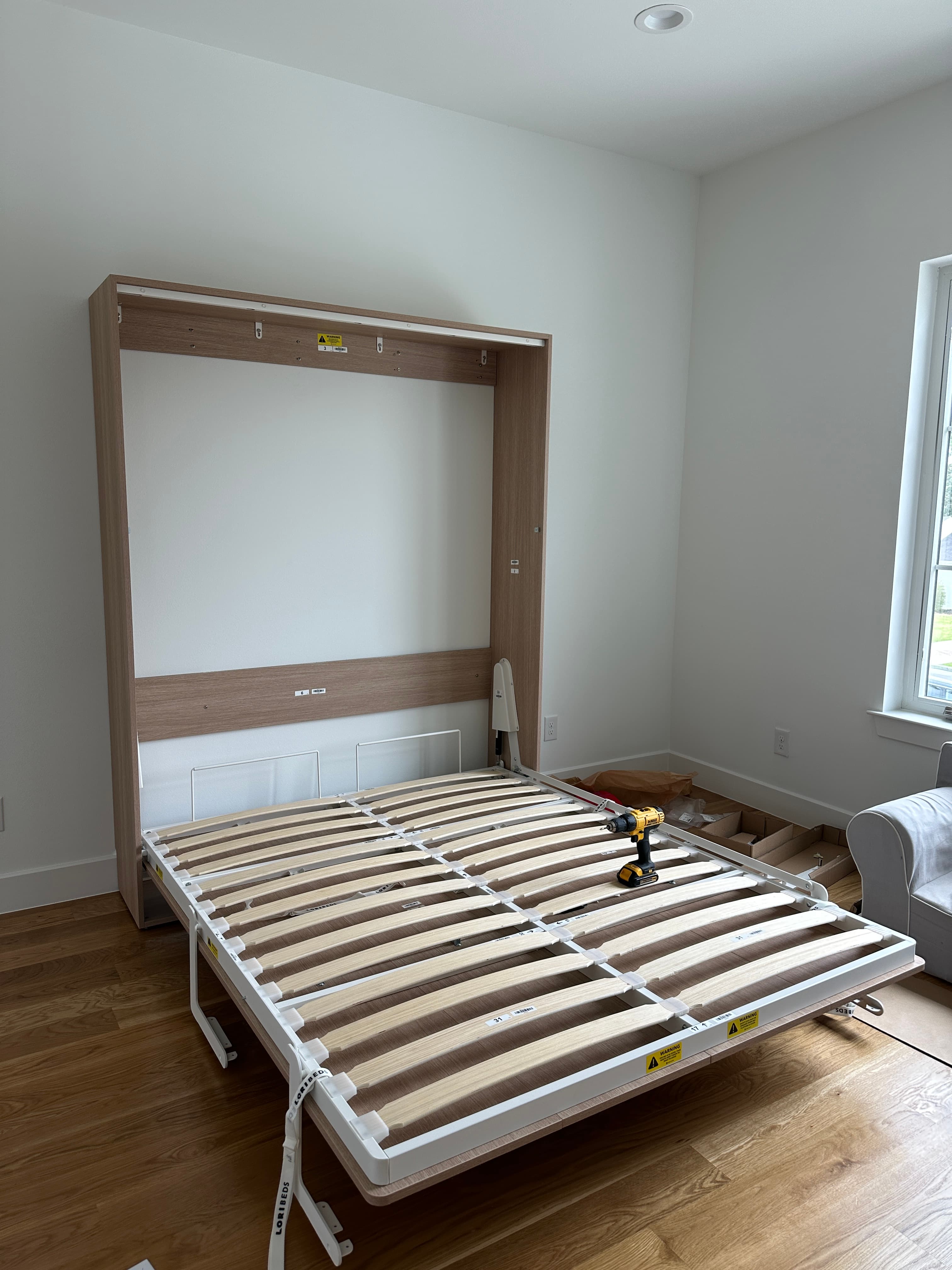 Light wooden bed frame in bright room
