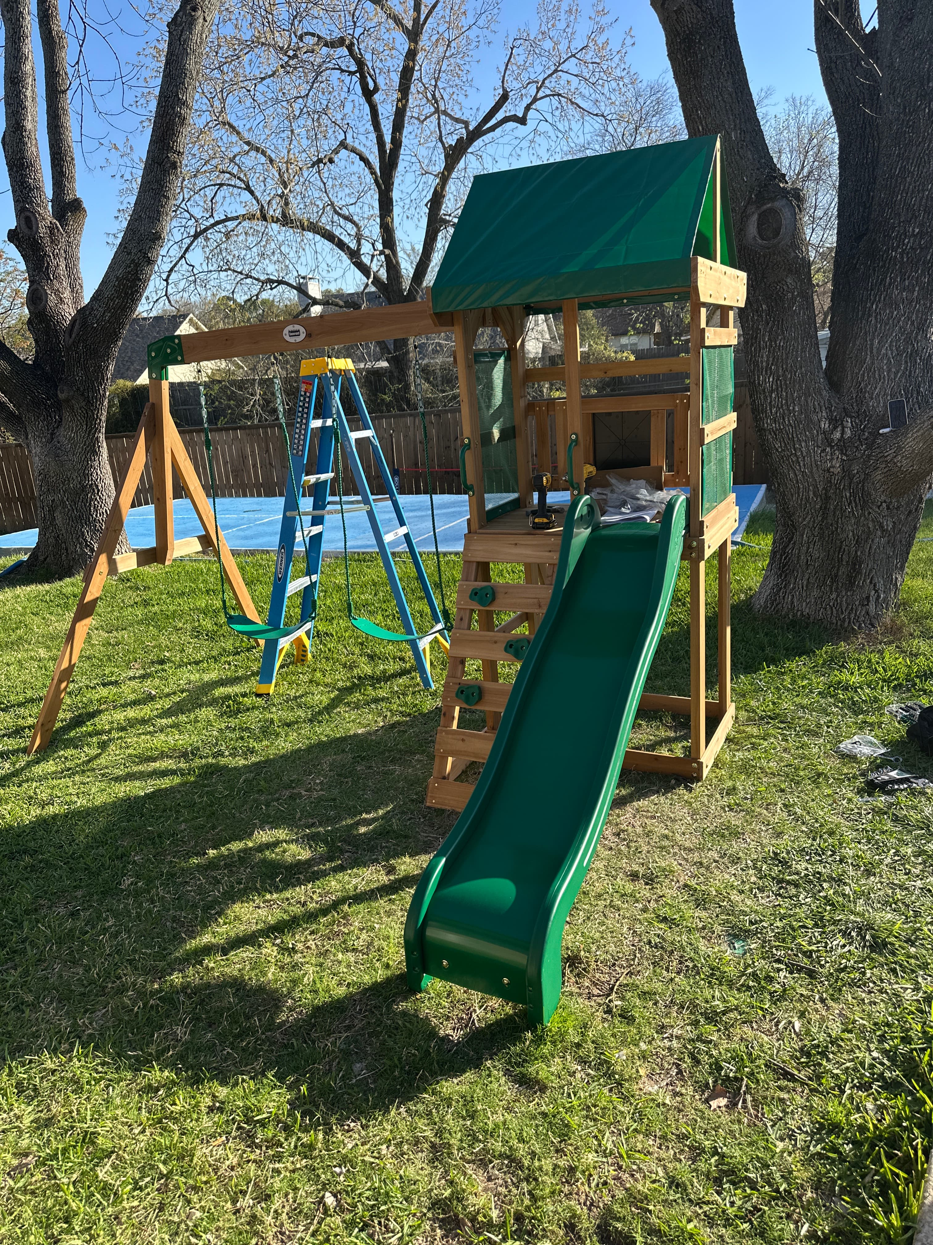Green-painted outdoor structure with picnic table