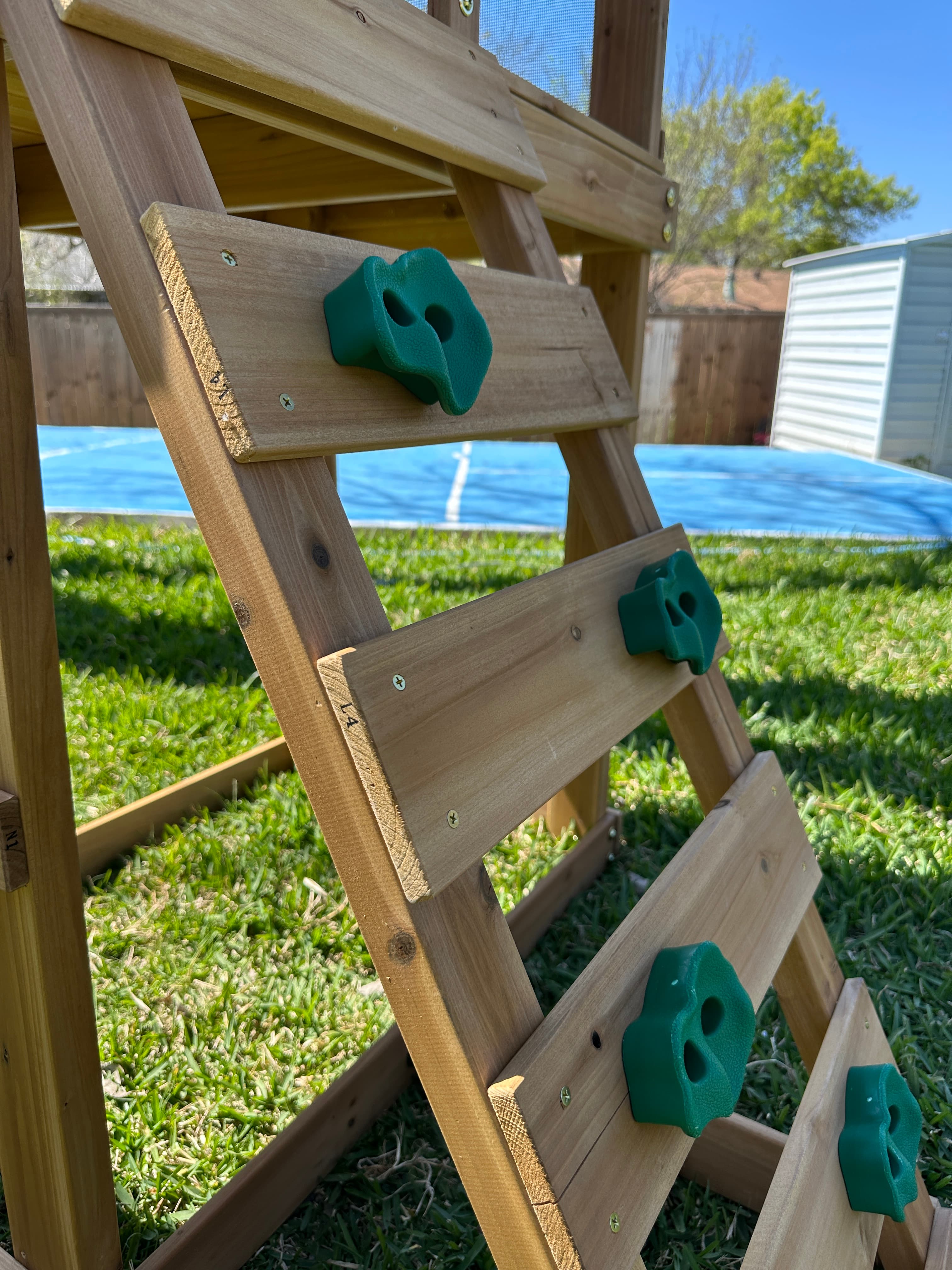 Outdoor play structure with green rubber components