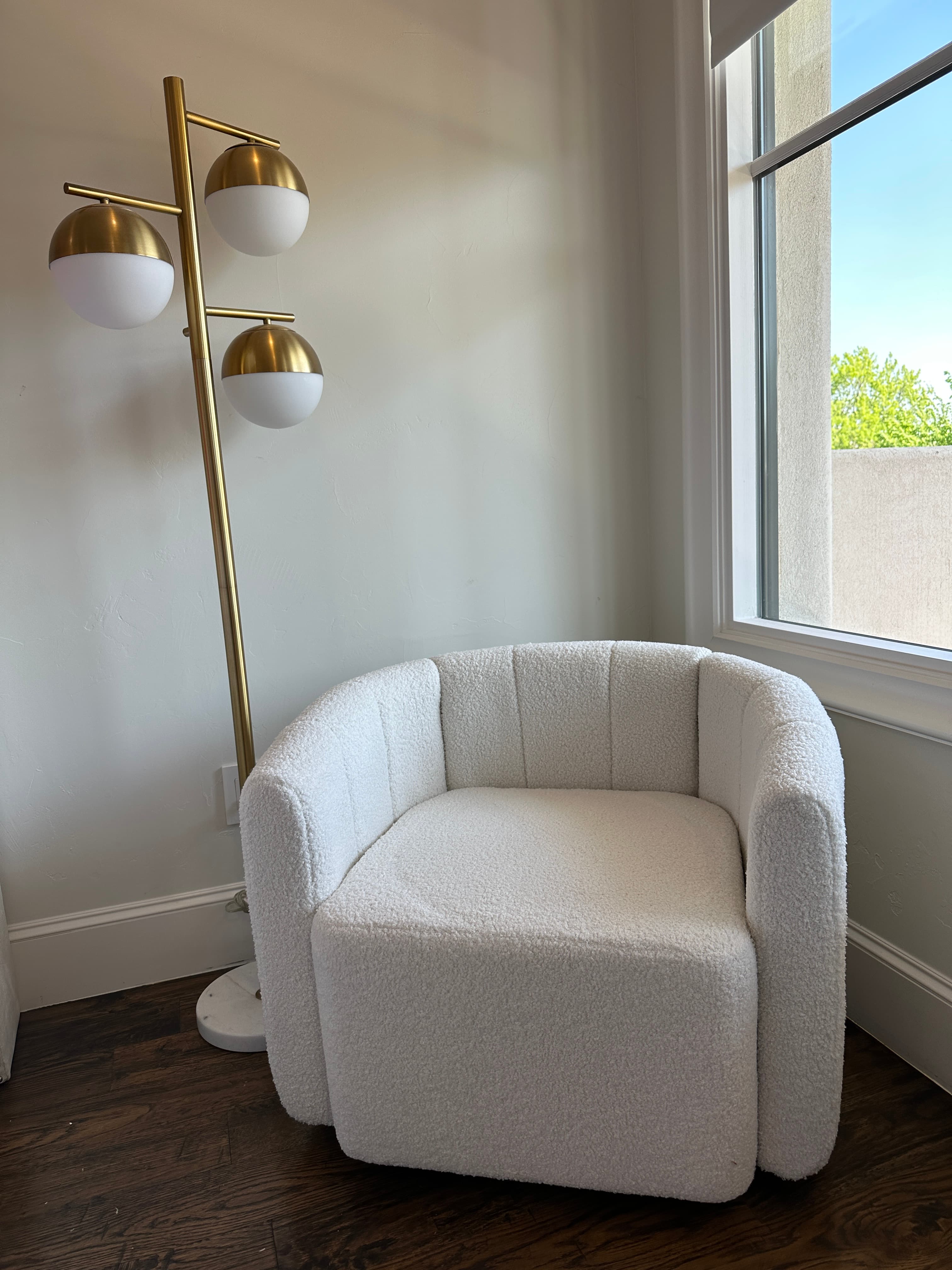 Modern curved white upholstered armchair