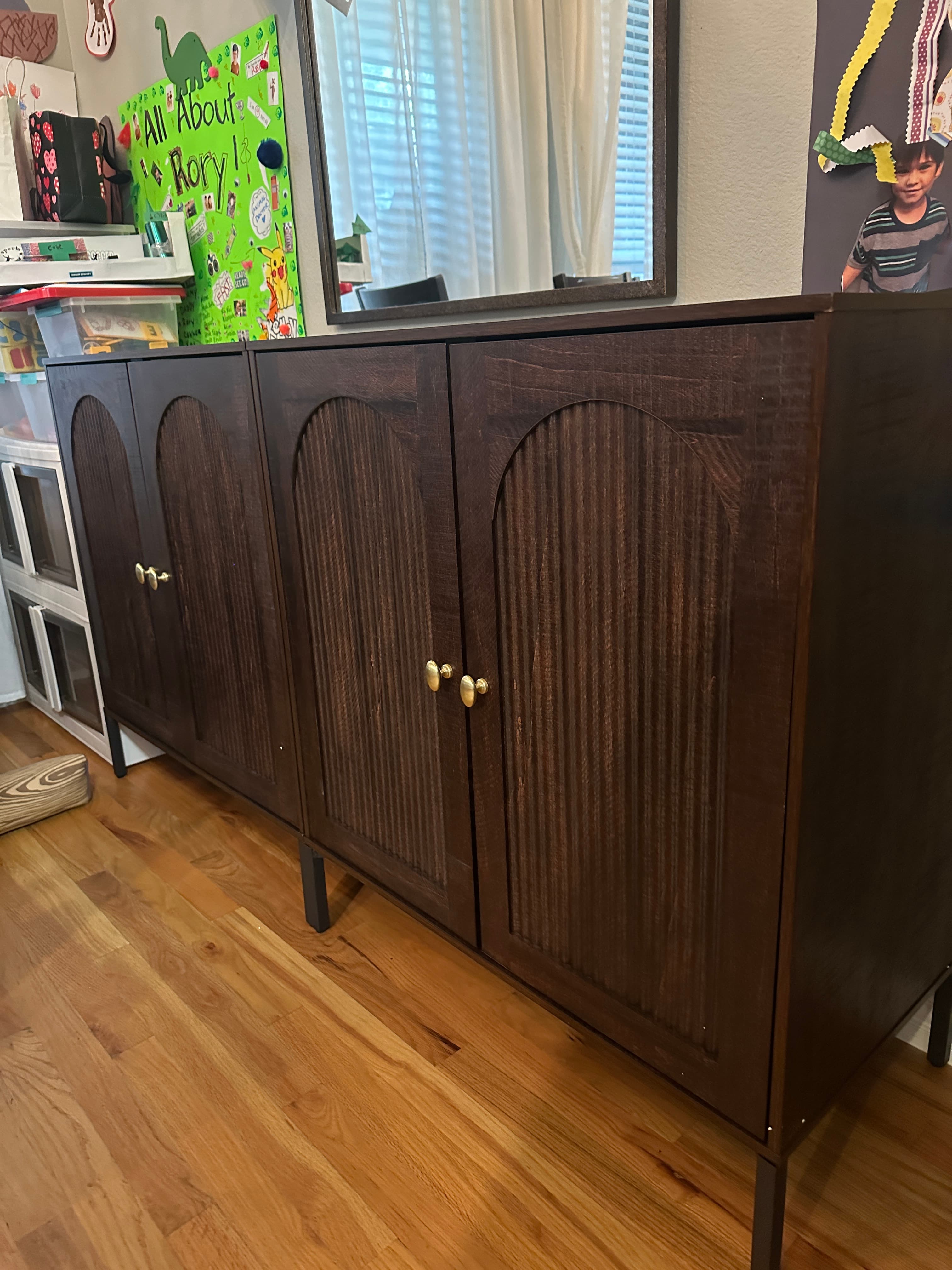 Dark wood chest of drawers with brass hardware