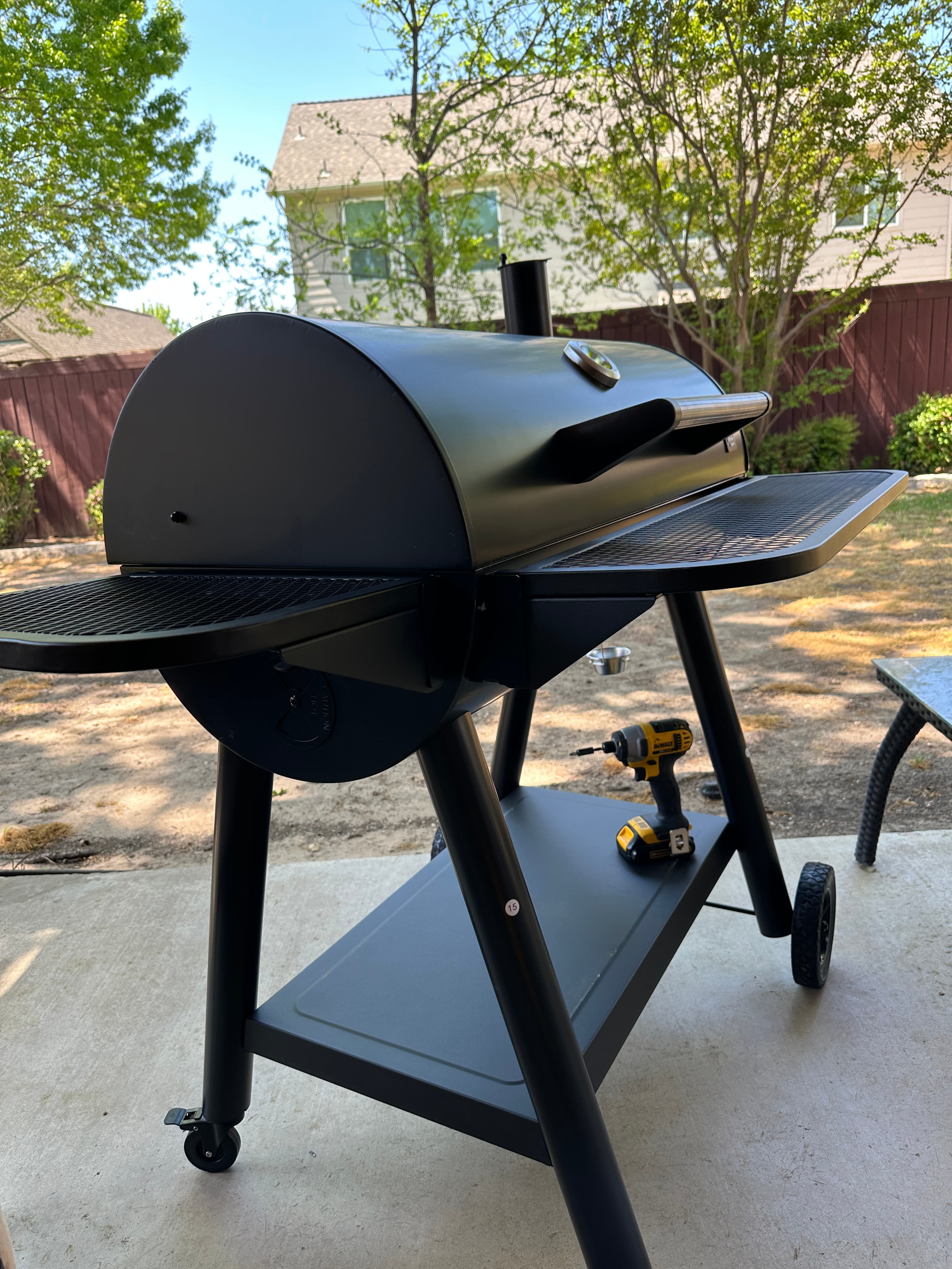 Black outdoor grill assembly side view